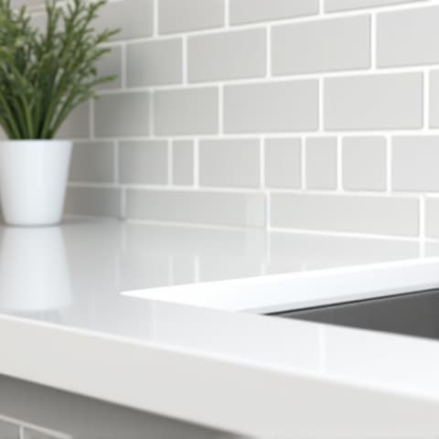 Bright white quartz countertops paired with a subway tile backsplash in a San Antonio kitchen renovation, creating a clean and timeless aesthetic. The quartz provides a low-maintenance and hygienic surface for cooking and dining.